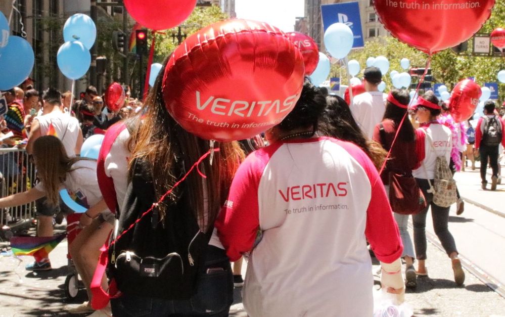 Members of #TeamVtas marching in the Pride Parade route before the Veritas double-decker bus.