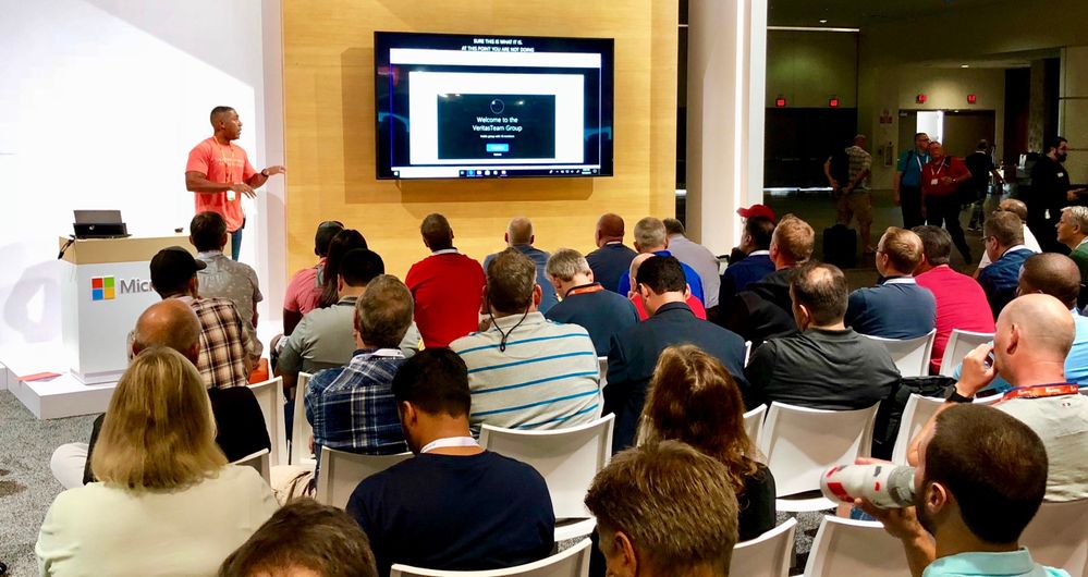 Presenting on the benefits of Veritas data management and protection solutions at MS Ignite 2018 to a crowd of event attendees.