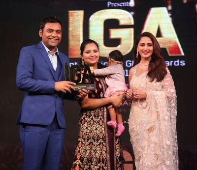 Varun and his family accepting an IGA Award
